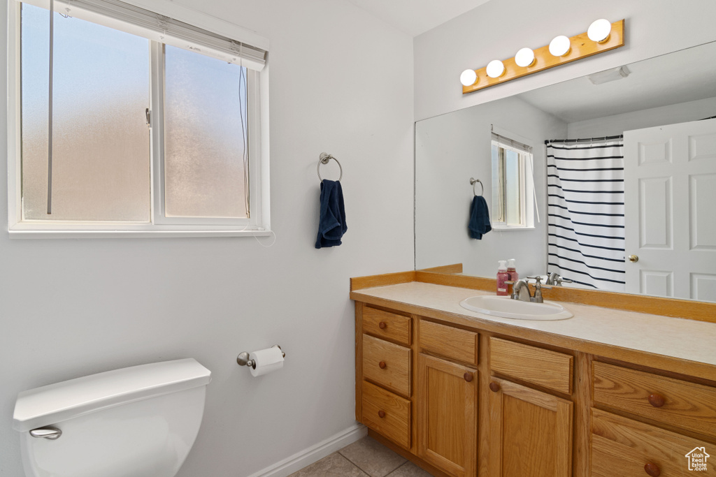 Bathroom with vanity, tile patterned flooring, and curtained shower