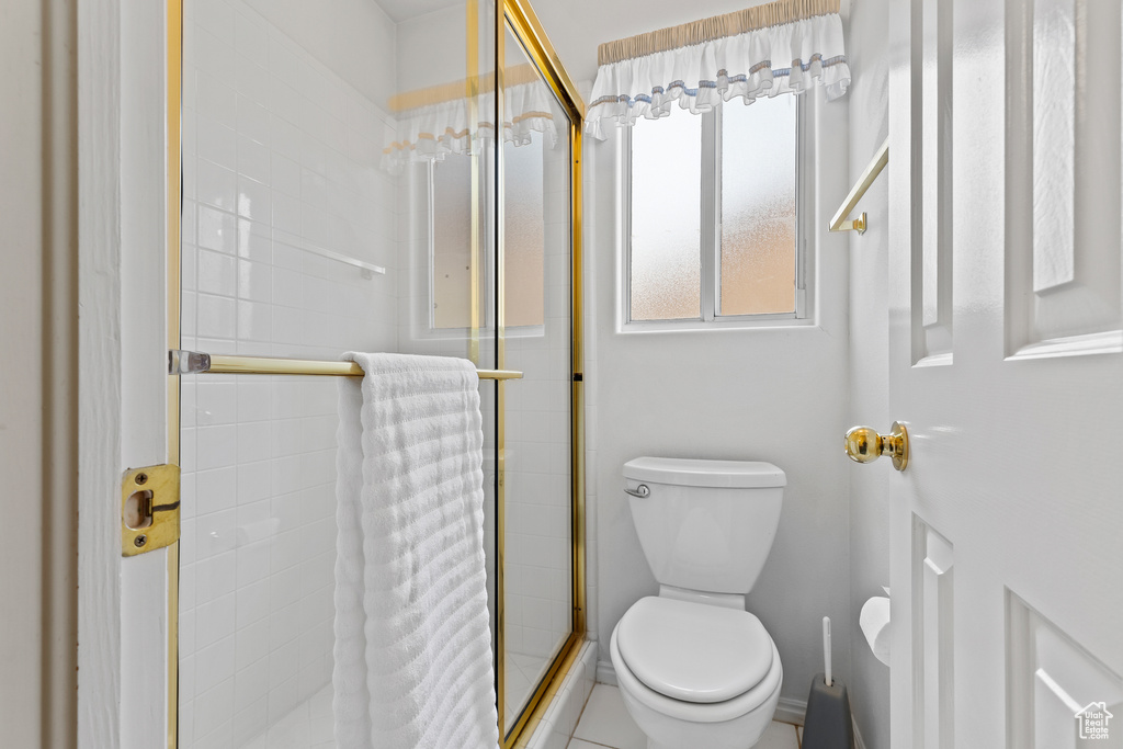 Full bathroom featuring a shower stall and toilet