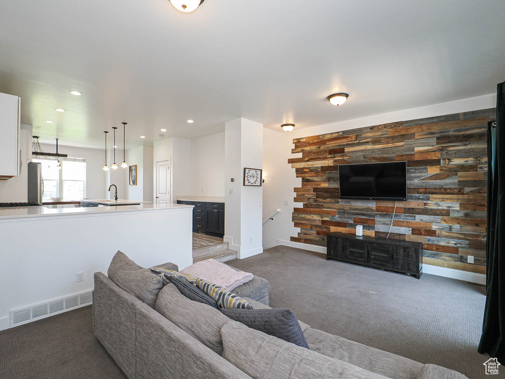 Living room with dark carpet and recessed lighting