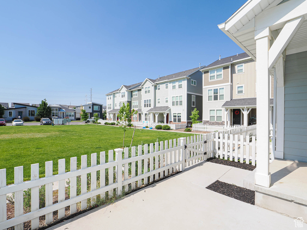 Porch featuring a residential view and a fenced front yard