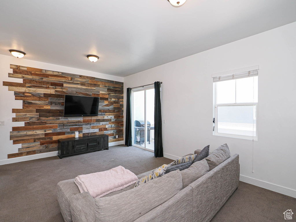 Carpeted living area with baseboards