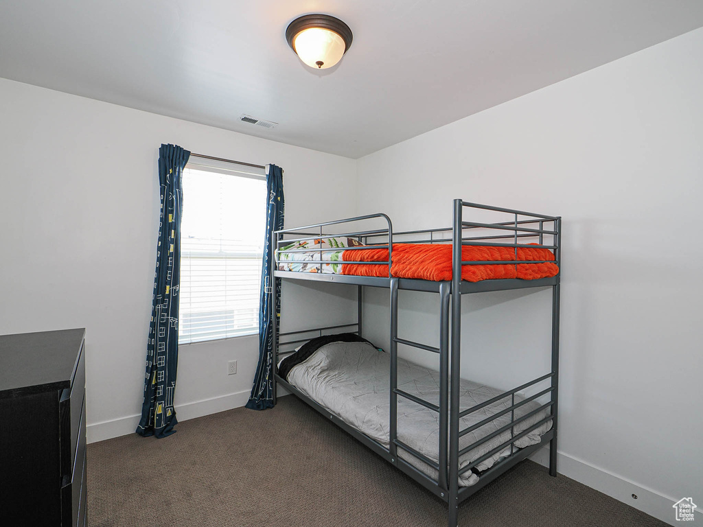 Bedroom featuring baseboards and carpet flooring