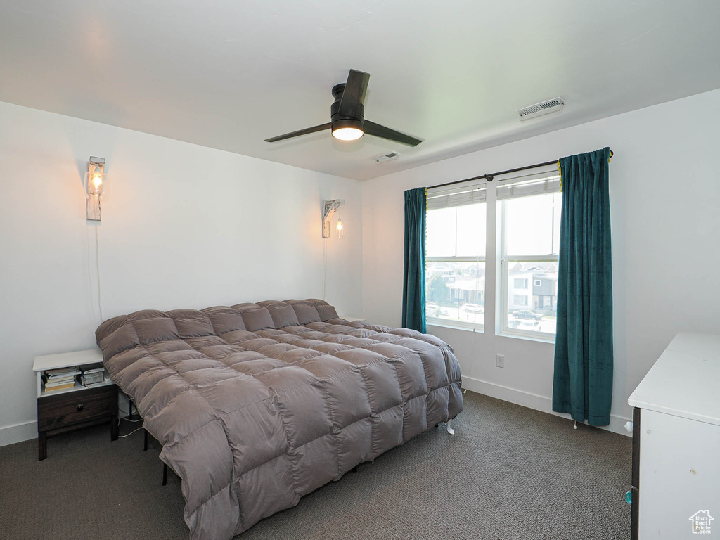 Carpeted bedroom with baseboards and ceiling fan