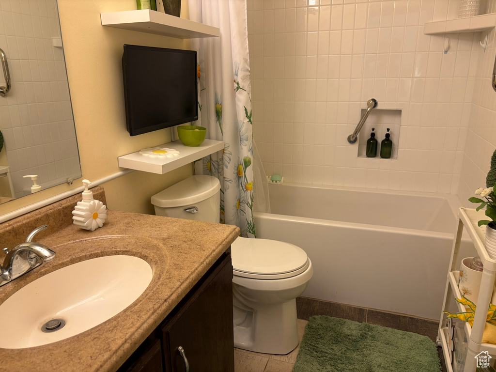 Bathroom with shower / tub combo with curtain, vanity, and tile patterned floors