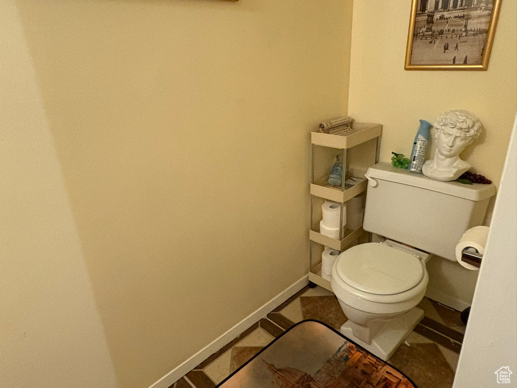 Bathroom with toilet and tile patterned flooring