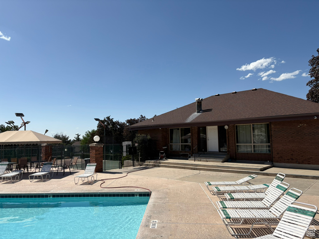 Community pool featuring a patio