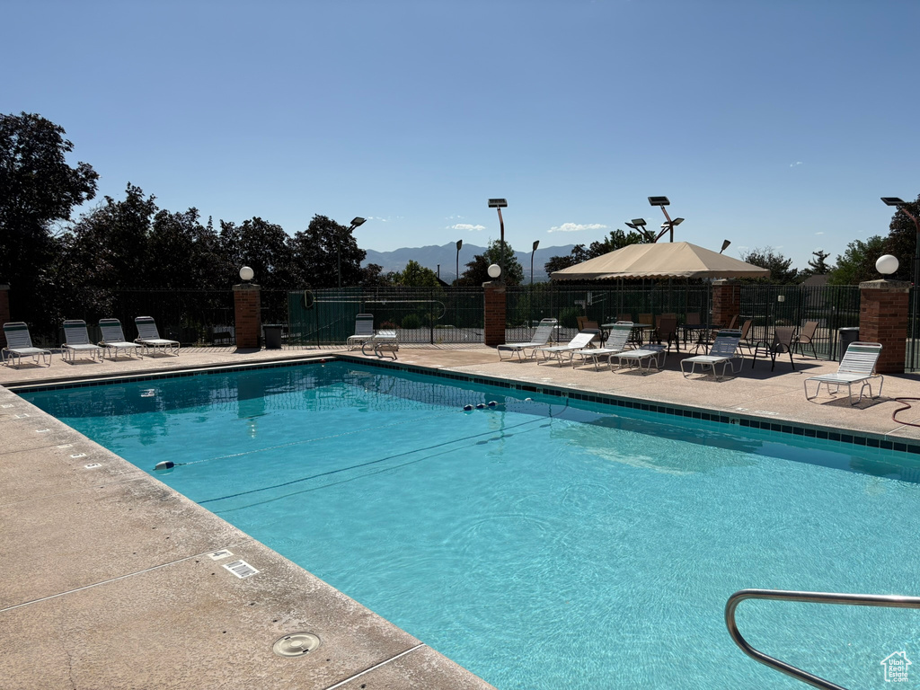 Community pool featuring a patio and a mountain view