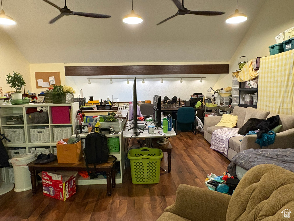 Living area with a ceiling fan, lofted ceiling, wood finished floors, and track lighting
