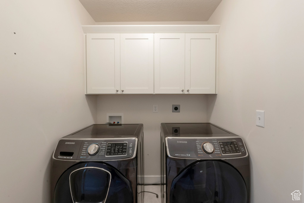 Laundry room with cabinet space and washing machine and clothes dryer