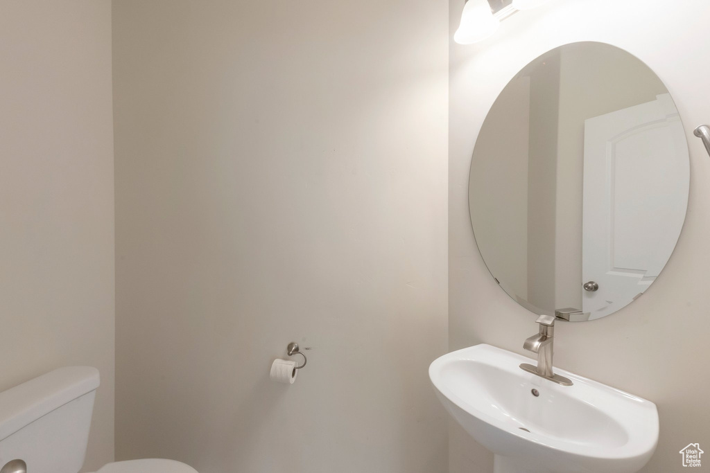 Half bath with a sink and toilet