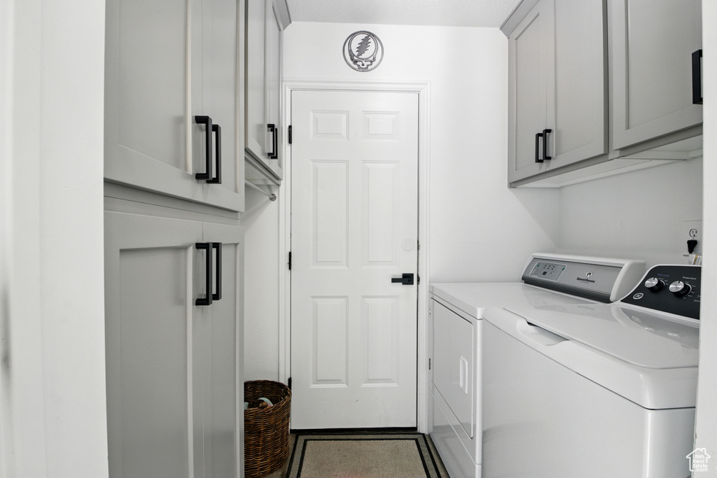 Laundry area with independent washer and dryer and cabinet space