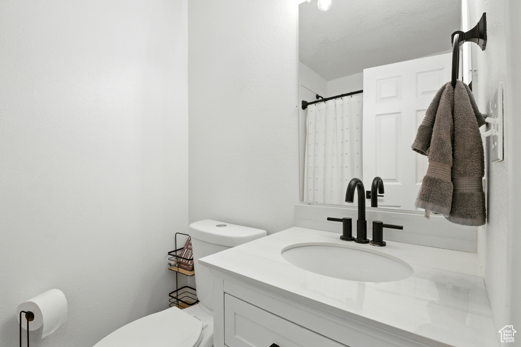 Full bathroom featuring toilet and vanity