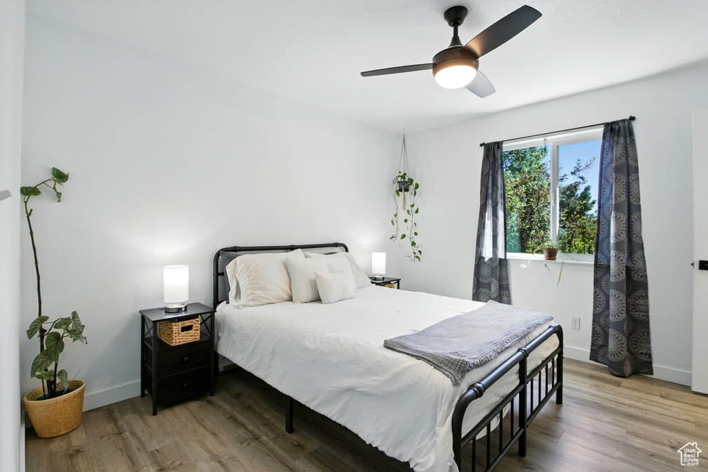 Bedroom with light wood finished floors and ceiling fan