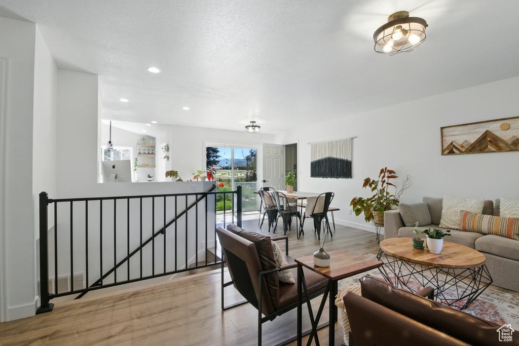 Living room featuring light wood finished floors and recessed lighting