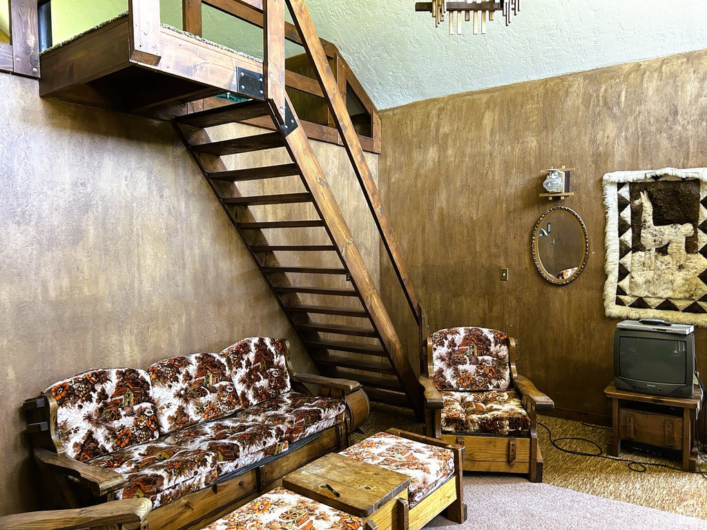 Living room with stairs and carpet