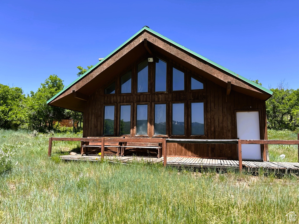 Back of property featuring a wooden deck