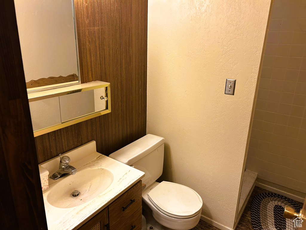 Bathroom with vanity, a textured wall, and a shower