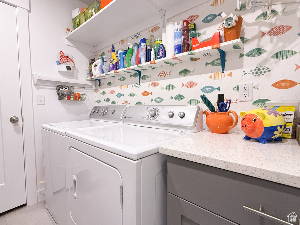 Laundry area featuring washer and clothes dryer and light tile patterned floors