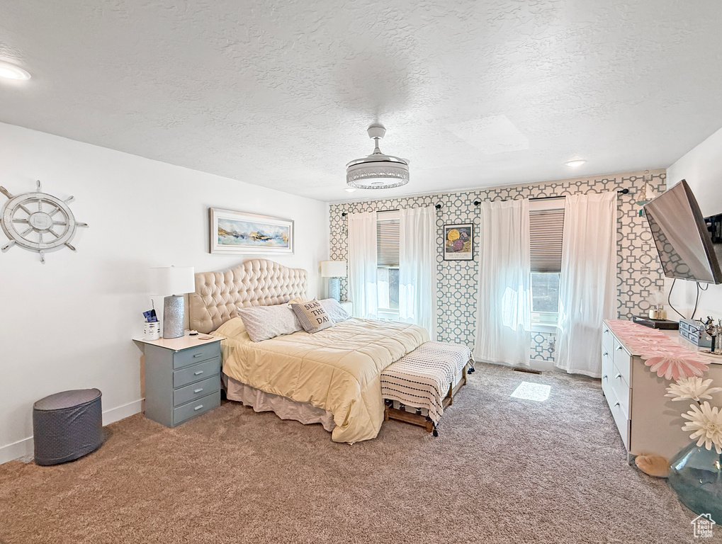 Bedroom with carpet flooring and a textured ceiling
