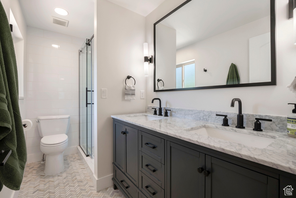 Bathroom with double vanity and a stall shower