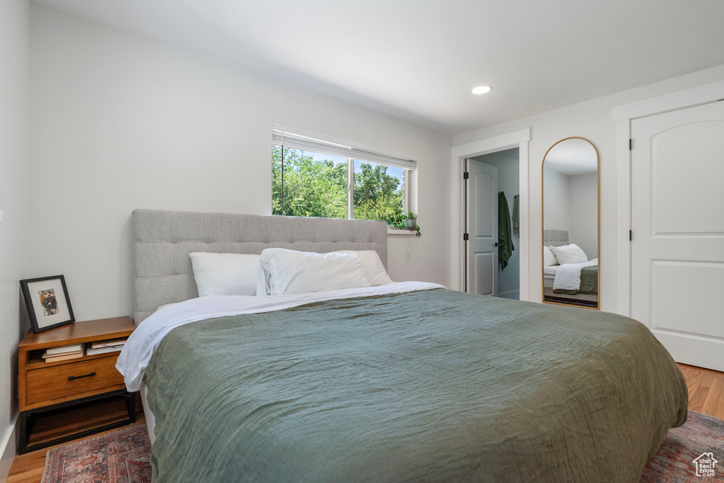 Bedroom with wood finished floors and recessed lighting