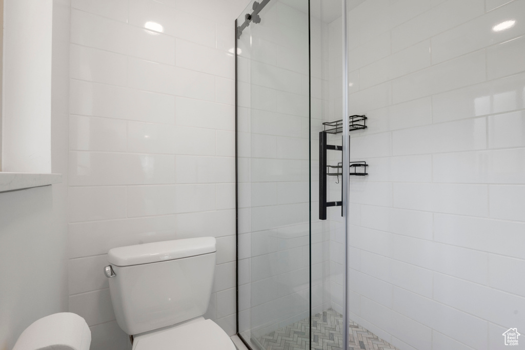 Bathroom featuring toilet and a shower stall