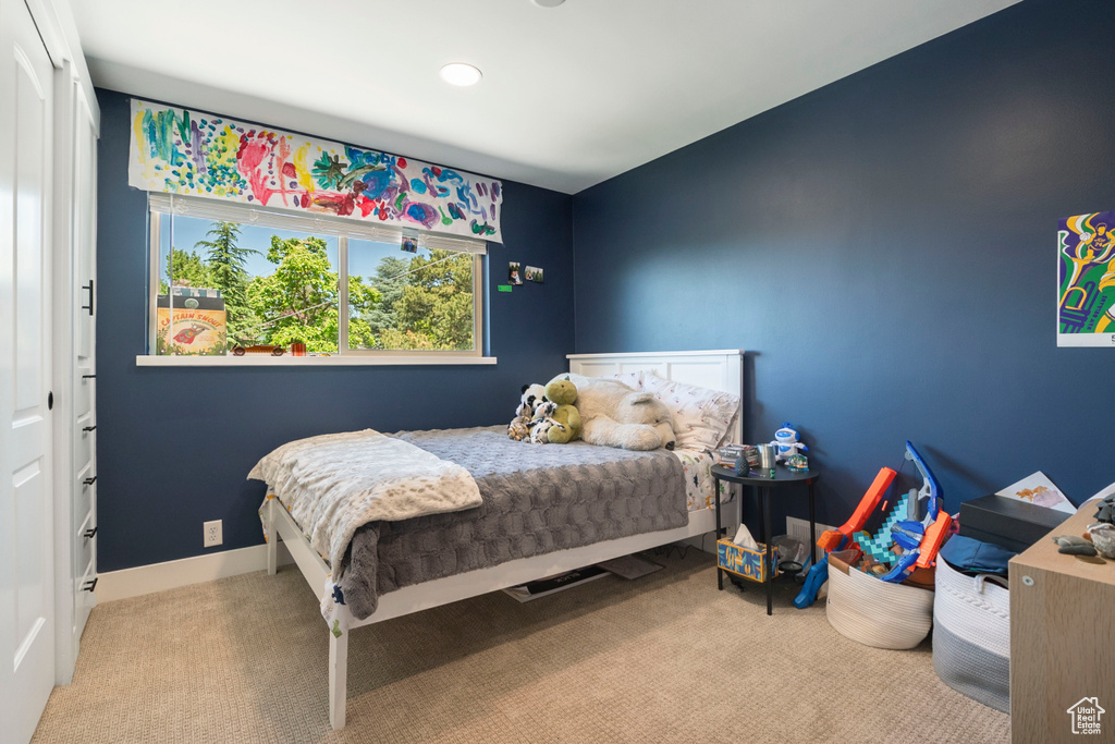Carpeted bedroom with recessed lighting