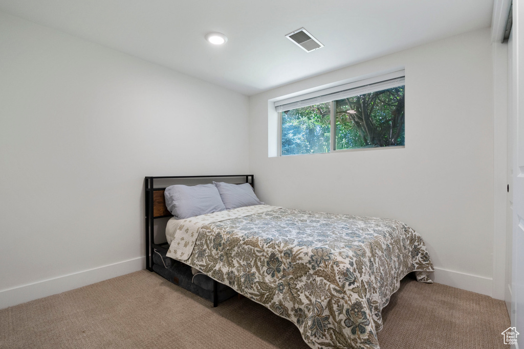 Carpeted bedroom featuring baseboards