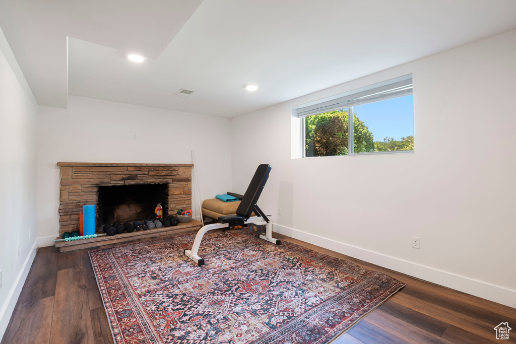 Living area featuring dark wood-style flooring, a fireplace, and recessed lighting