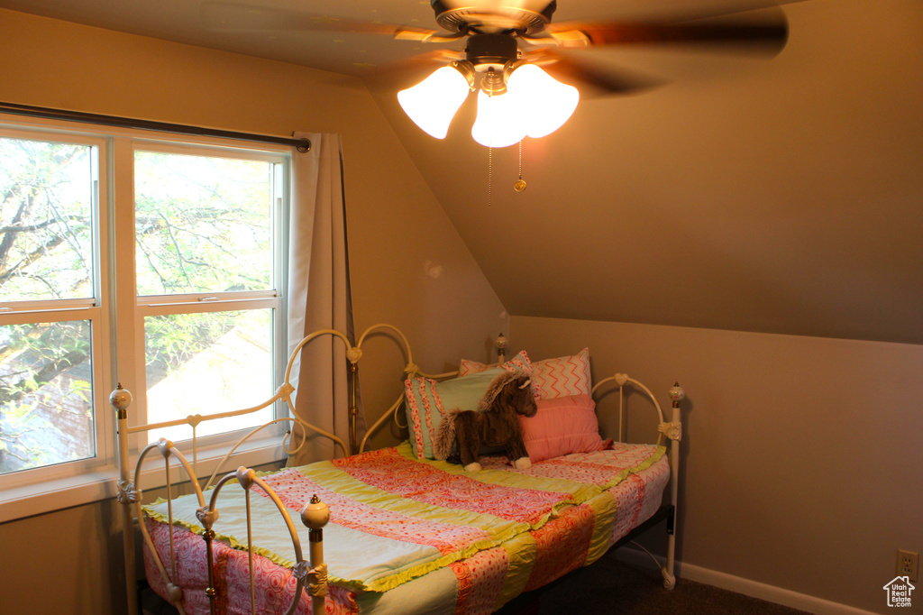Bedroom with lofted ceiling, carpet, and a ceiling fan