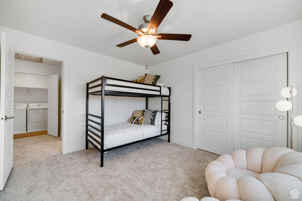 Bedroom with washer and dryer, carpet floors, a ceiling fan, and a closet