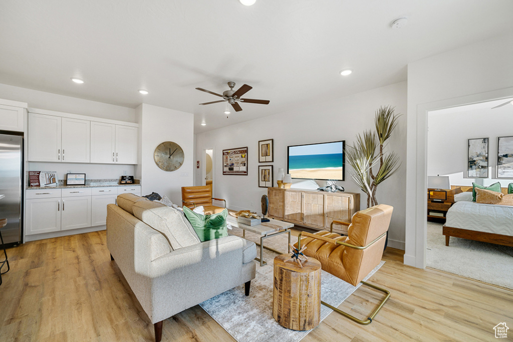 Living room featuring a ceiling fan, light wood finished floors, and recessed lighting