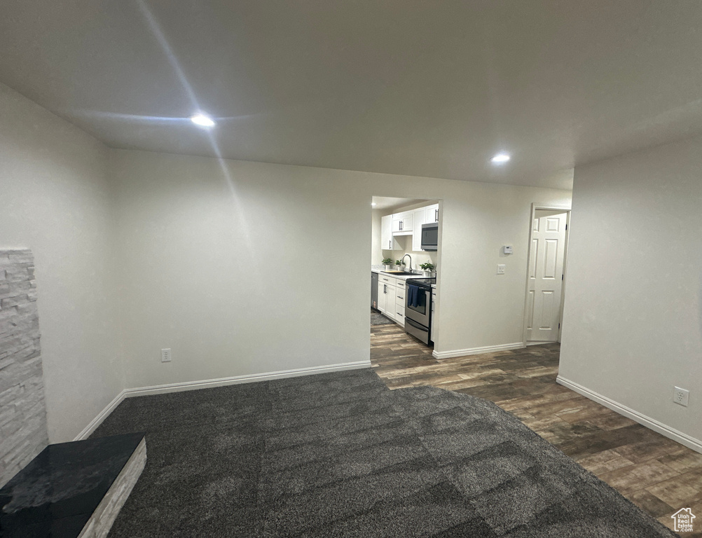 Below grade area with dark wood-type flooring and recessed lighting