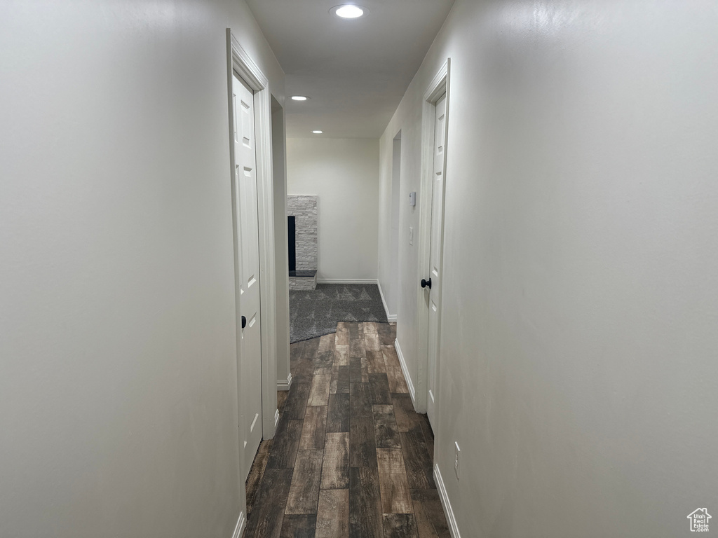 Hall with recessed lighting and dark wood-style floors