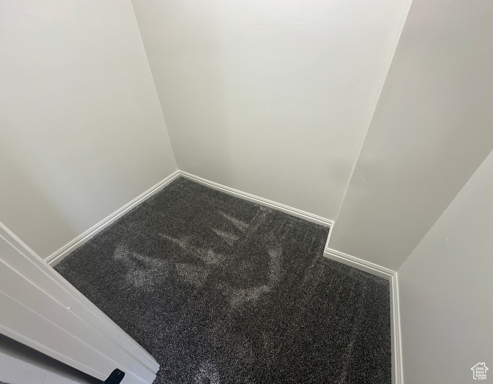 Detailed view of carpet flooring and baseboards