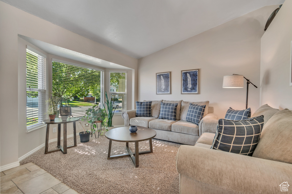 Living area with vaulted ceiling and baseboards