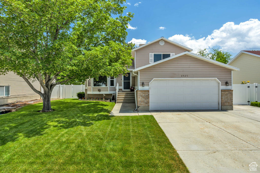 View of front of property with brick siding, an attached garage, and concrete driveway
