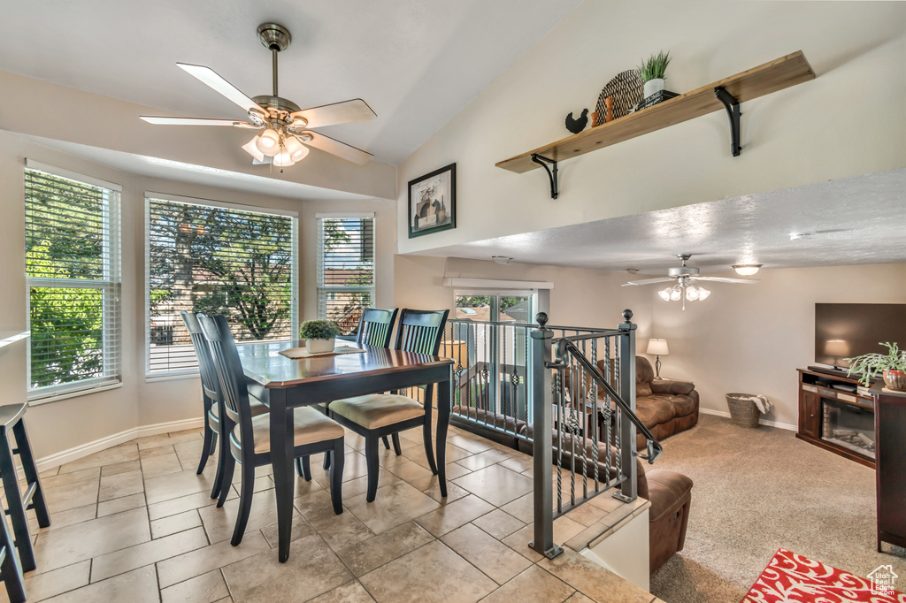 Dining space with ceiling fan and vaulted ceiling