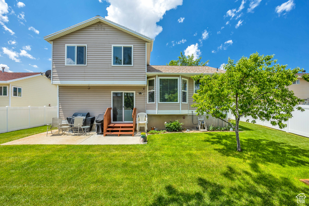 Back of house featuring a patio and a shingled roof