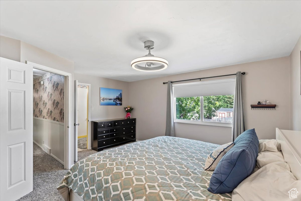 Bedroom featuring carpet floors and baseboards