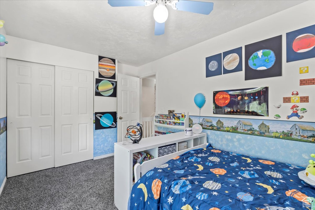 Bedroom with carpet floors, a closet, and a ceiling fan