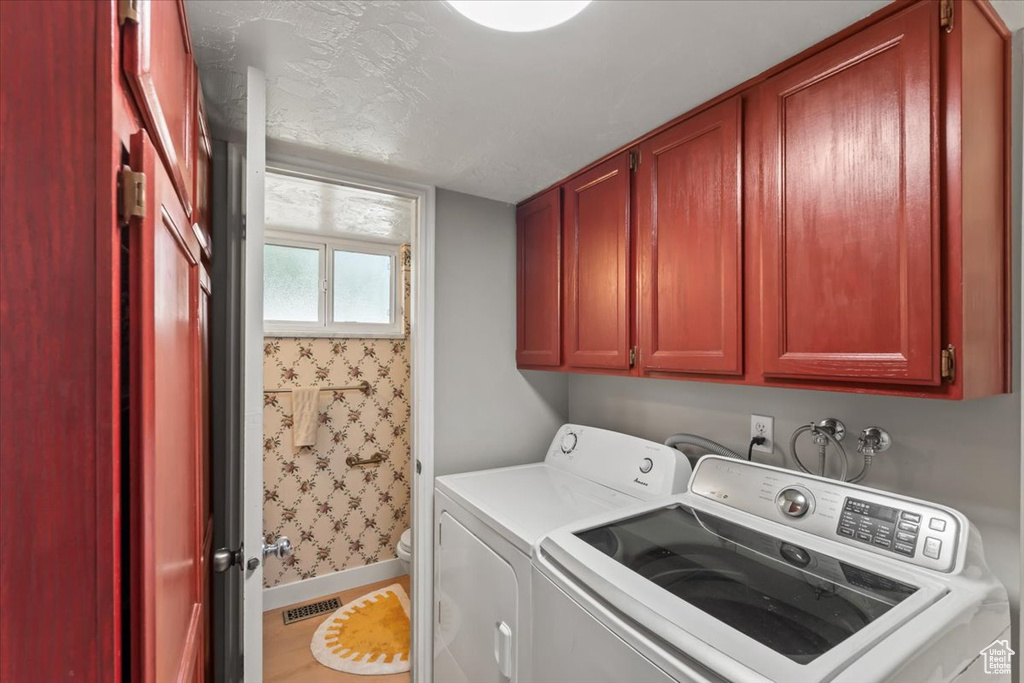 Laundry room with independent washer and dryer and cabinet space