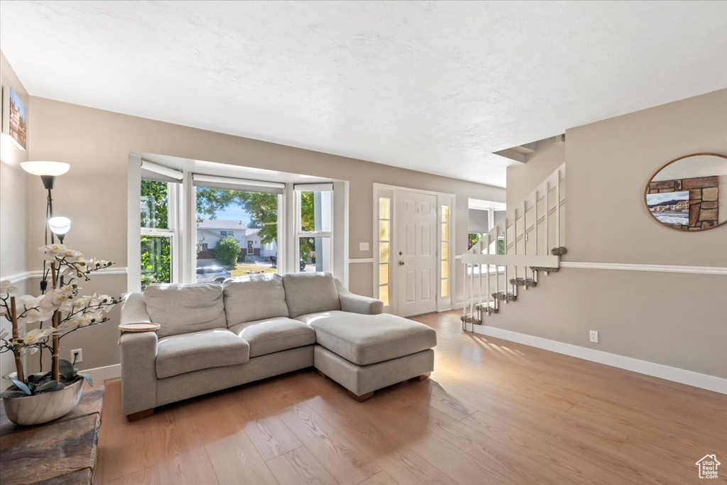 Living room with wood finished floors and stairway