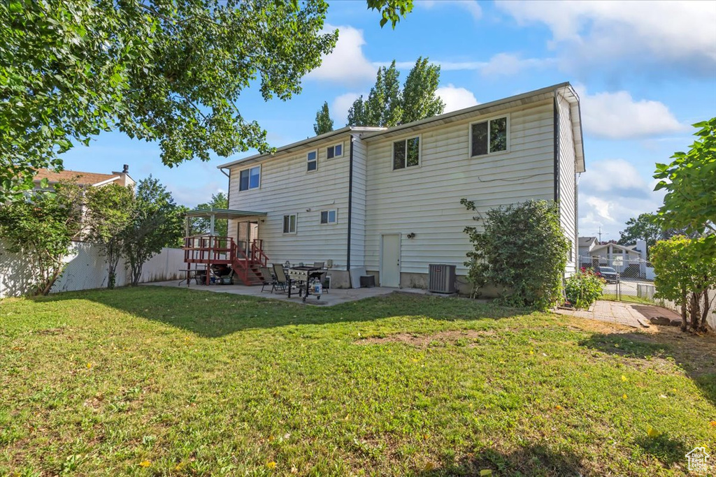 Rear view of house featuring a patio area and a fenced backyard