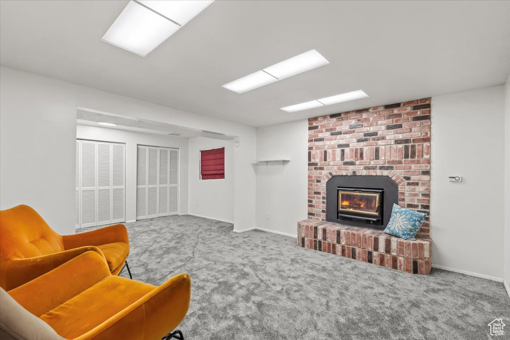 Living room with carpet and a fireplace