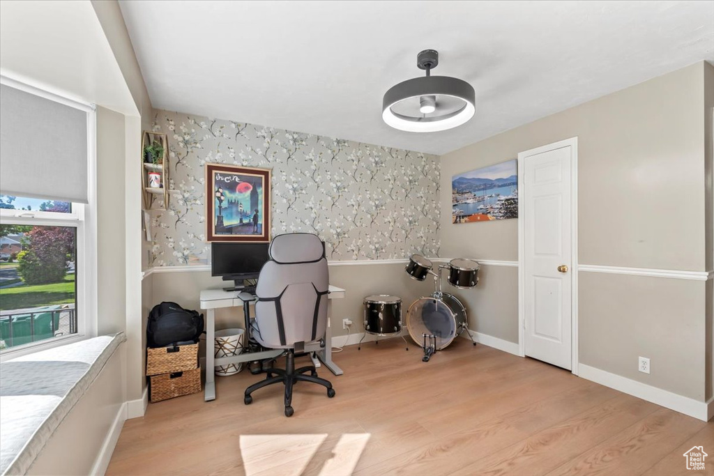 Office space featuring wood finished floors and wallpapered walls