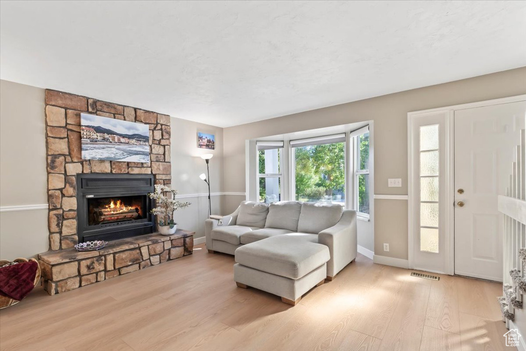 Living area featuring wood finished floors and a fireplace