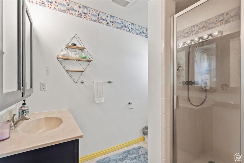 Bathroom with vanity and a shower stall