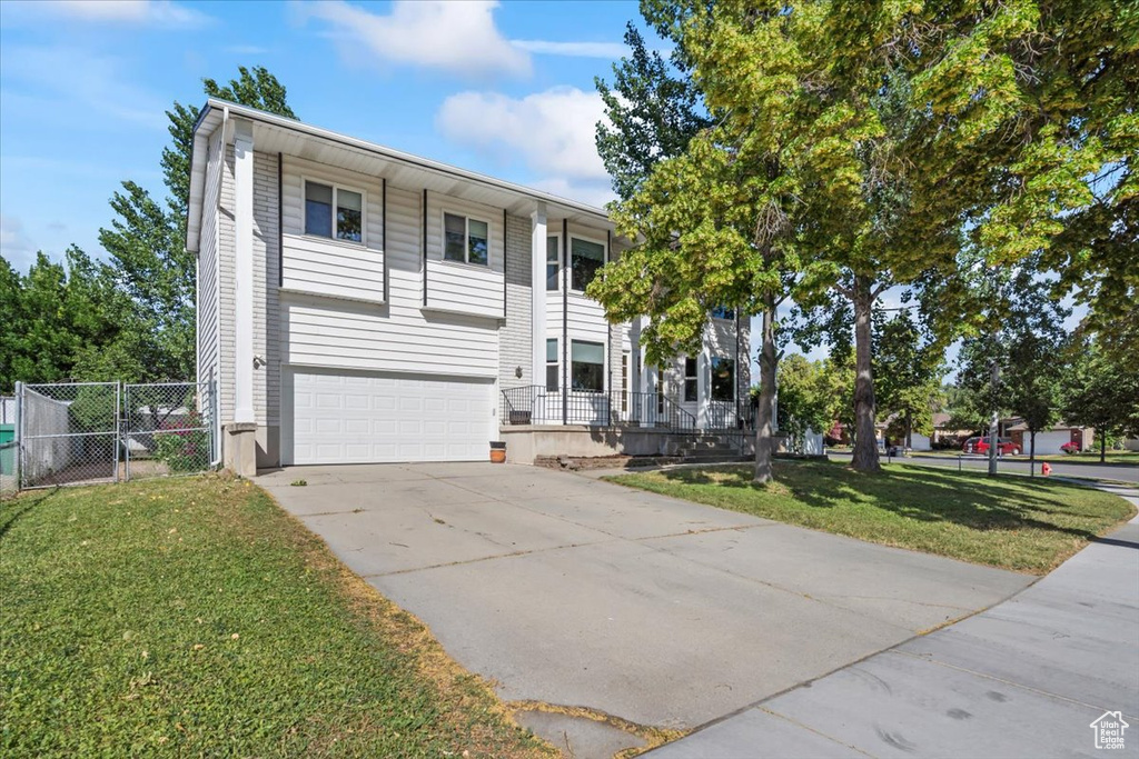 View of front of property featuring a garage and driveway