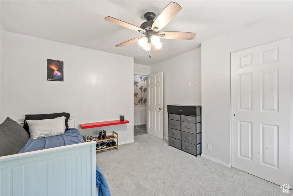 Carpeted bedroom with baseboards and ceiling fan